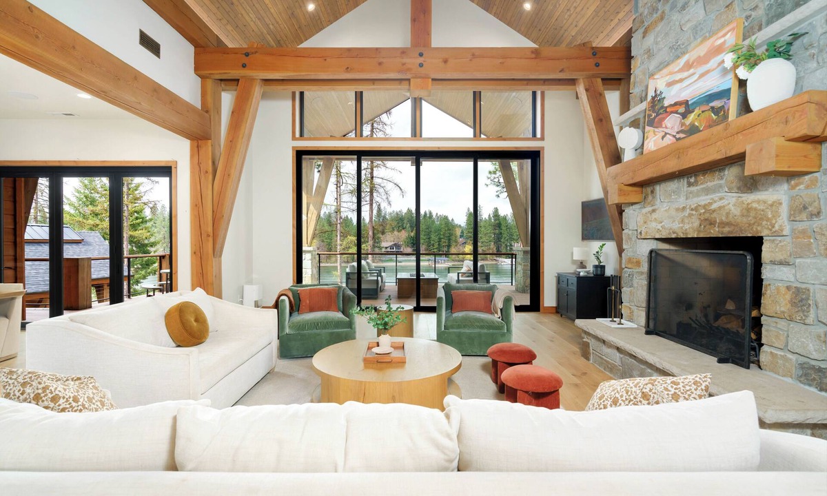 Coeur d'Alene House | A 5,200 sq ft home on the Spokane River, twelve minutes to Coeur d'Alene and ten to downtown Post Falls. Six bedrooms and five full baths across the main house and guest house, plus a private sandy beach, a dock, and a river-view hot tub.