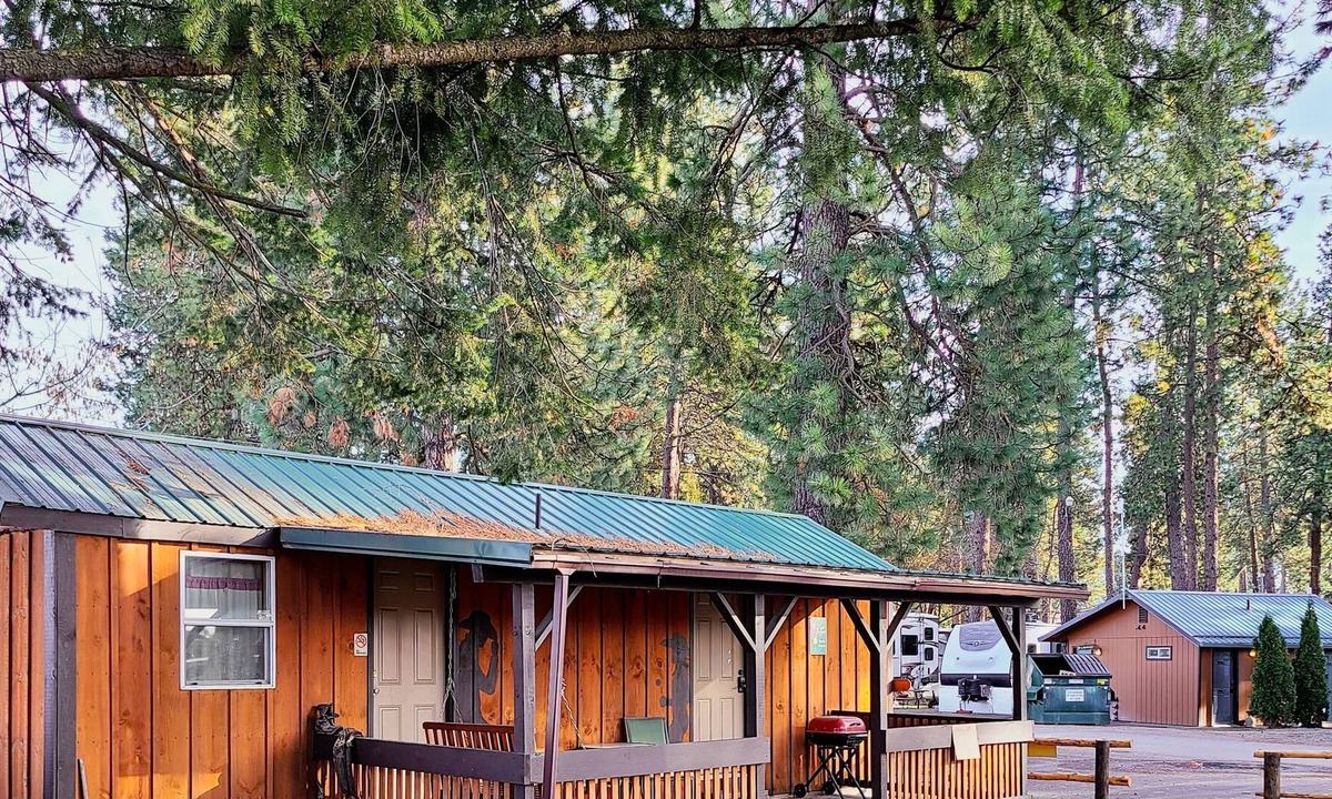 Coeur d'Alene Cabin | Cowboy Cabin - porch, queen bed, old-fashioned water pump in kitchen