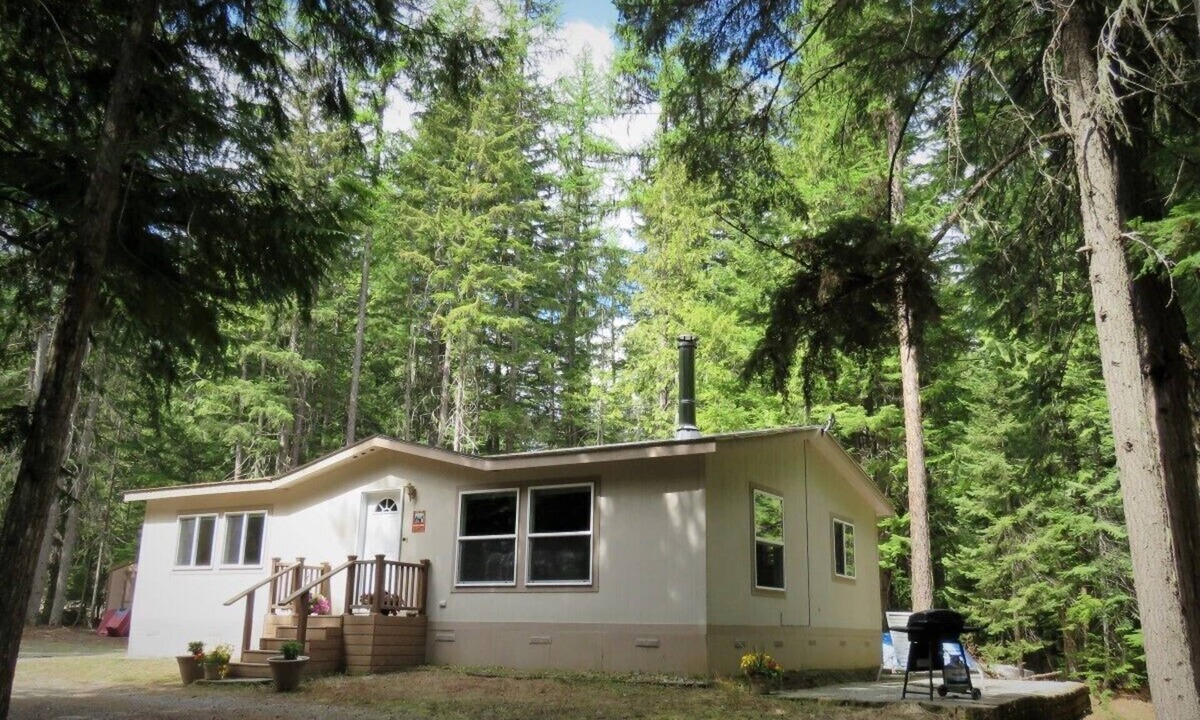 Priest River House | Located in a private wooded area with a lovely creekfront trail to explore.
