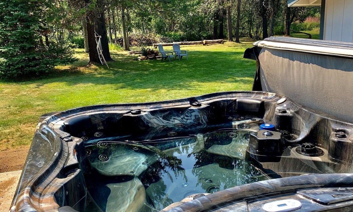 Wagon Wheel House | The Barndominium 167 with a Hot Tub on a 1/2 acre