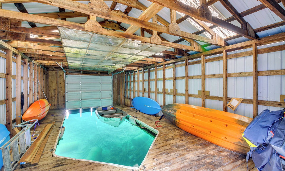 Bayview Cabin | Wake up to Lake Pend Oreille views, soak in the private hot tub, and paddle out from your dock. This lakefront Bayview cabin sleeps 10 with two decks, paddle boards, fire pit, barbeque, and covered boat slip. A unique family getaway in North Idaho!