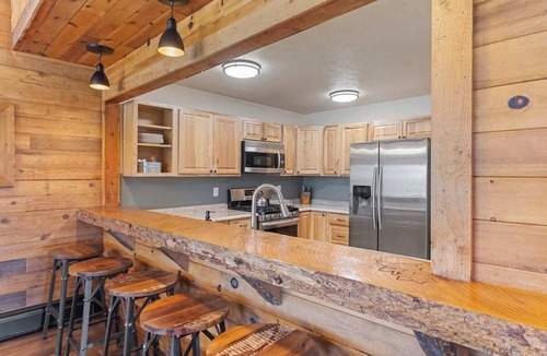 Clark Cabin | Comfortable private queen room in the True North Adventure Lodge. Includes a queen bed, private ensuite bathroom, and access to shared amenities like the kitchen, great room, and hot tub. Great for couples or solo travelers.