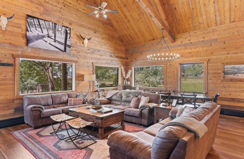 Clark Cabin | Comfortable private queen room in the True North Adventure Lodge. Includes a queen bed, private ensuite bathroom, and access to shared amenities like the kitchen, great room, and hot tub. Great for couples or solo travelers.