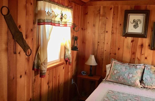 Coeur d'Alene Cabin | Cowboy Cabin - porch, queen bed, old-fashioned water pump in kitchen