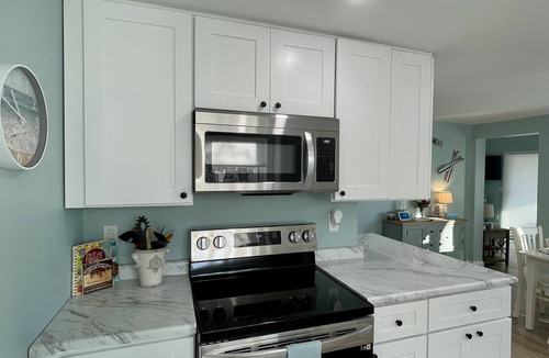 Oscoda Cottage | Cozy riverfront cottage with an easy beach-inspired coastal MI vibe!