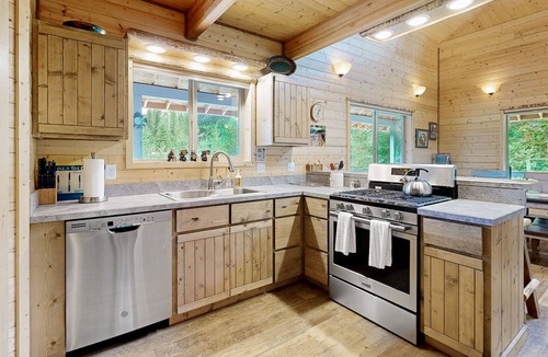 Dixie House | Dog-friendly riverfront home near town with deck, water views, & fireplace
