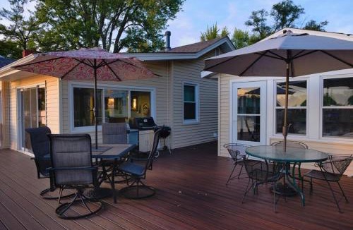 Moline House | Eclectic Riverside Home 3 Season Room Large Deck
