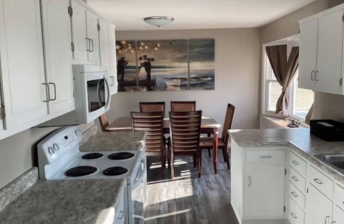 Altoona House | Enjoy golf course views with hot tub and fire pit. Three bedrooms, sleeps seven.