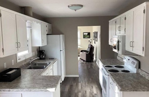 Altoona House | Enjoy golf course views with hot tub and fire pit. Three bedrooms, sleeps seven.