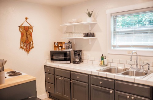 Phoenix House | Escape to this artsy 2-bedroom MCM Guesthouse in charming Phoenix, OR. Unwind in the luxurious spa soaking tub after exploring Southern Oregon. Features high-end design for a stylish, quiet retreat.