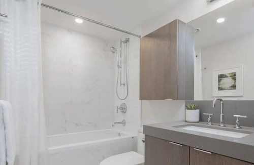 South Lake Union House | Level Seattle- Enjoy city views in our studio suite with one king bed, furnished kitchen and a deluxe bathroom.