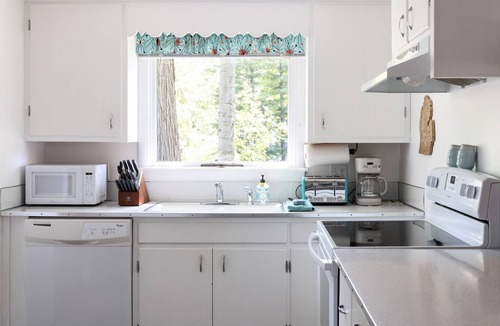 Traverse City Cottage | Long Lake Stone Cottage in Traverse City Frontage Kayaks Fire Pit Pet friendly