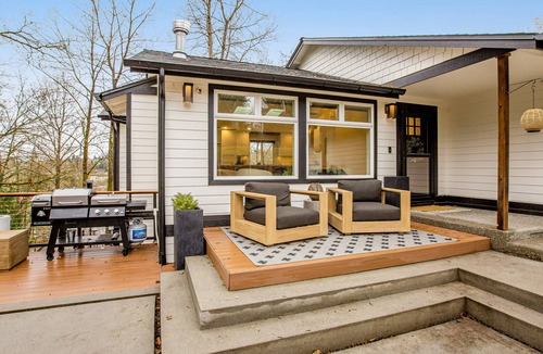 Milton House | Modern home with outdoor fireplace, rock-wall, & walk-in shower