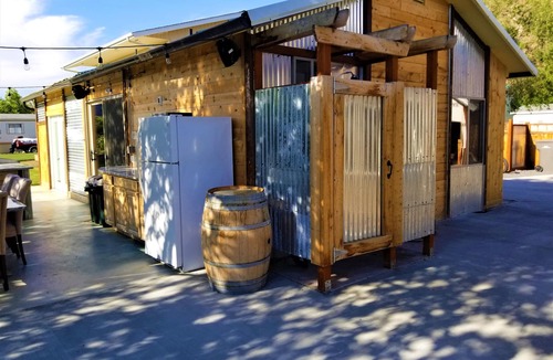 Sunland Estates House | Outdoor kitchen with grill and professional griddle