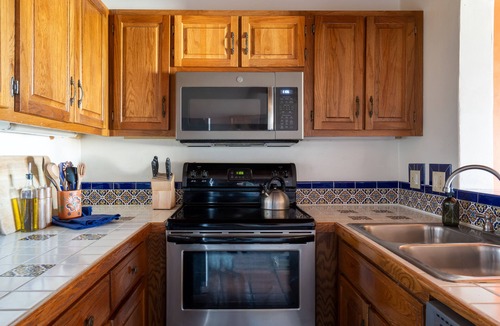 Arroyo Seco Apartment | Queen adobe studio with full kitchen, in-unit washer/dryer & fireplace. Private balcony + valley views. 15 min to Taos Ski Valley · 5 to Arroyo Seco. Sleeps 2.