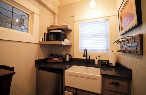 Siskiyou-Hargadine Historic District Apartment | Relax in the luxurious 1-bedroom Louisa Suite at RedTail Inn. Enjoy a double rain shower, plush linens, and a shared hot tub. Located near downtown Ashland, with off-street parking and high-speed WiFi.