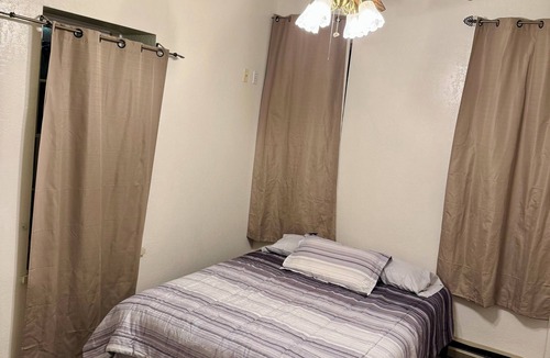 Spillville Apartment | Room 1: Sleep Where Prohibition Secrets Were Made - Historic Escape!