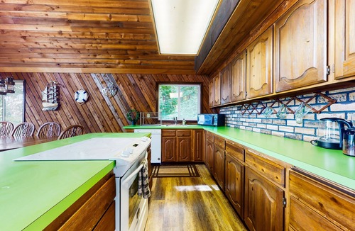 Anderson Island House | Sound view home full of vintage charm with game room, wood stove, & gas grill
