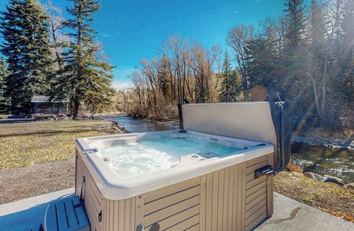 South Fork House | Spacious cabin with river views, private hot tub, sun room, and full kitchen!