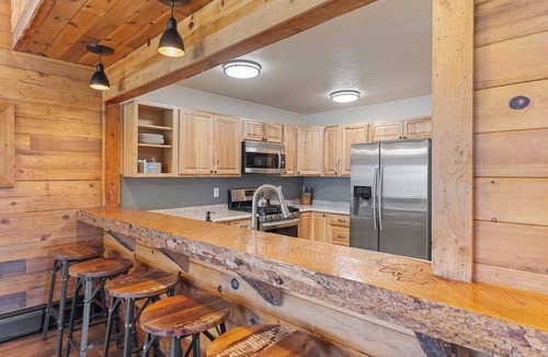 Clark Cabin | Spacious private king suite in the True North Adventure Lodge. Includes a king bed, private ensuite bathroom, and access to shared lodge amenities like the kitchen, great room, and hot tub. Ideal for couples or guests wanting extra space.