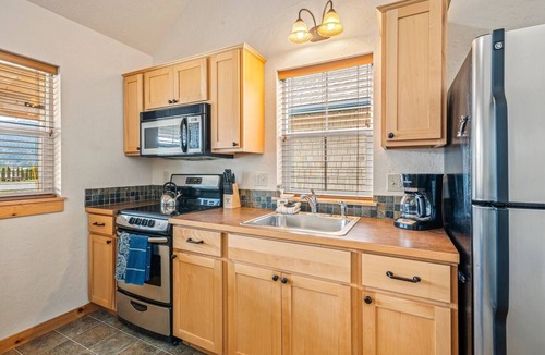 Dover Bay House | Unwind at Fish Tales Bungalow, a charming coastal-style hideaway just steps from the lake. Enjoy resort amenities, trails, and the tranquil Dover Bay setting.