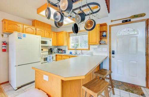 Bayview Cabin | Wake up to Lake Pend Oreille views, soak in the private hot tub, and paddle out from your dock. This lakefront Bayview cabin sleeps 10 with two decks, paddle boards, fire pit, barbeque, and covered boat slip. A unique family getaway in North Idaho!