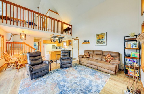 Bayview Cabin | Wake up to Lake Pend Oreille views, soak in the private hot tub, and paddle out from your dock. This lakefront Bayview cabin sleeps 10 with two decks, paddle boards, fire pit, barbeque, and covered boat slip. A unique family getaway in North Idaho!