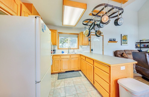 Bayview Cabin | Wake up to Lake Pend Oreille views, soak in the private hot tub, and paddle out from your dock. This lakefront Bayview cabin sleeps 10 with two decks, paddle boards, fire pit, barbeque, and covered boat slip. A unique family getaway in North Idaho!