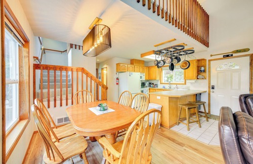 Bayview Cabin | Wake up to Lake Pend Oreille views, soak in the private hot tub, and paddle out from your dock. This lakefront Bayview cabin sleeps 10 with two decks, paddle boards, fire pit, barbeque, and covered boat slip. A unique family getaway in North Idaho!
