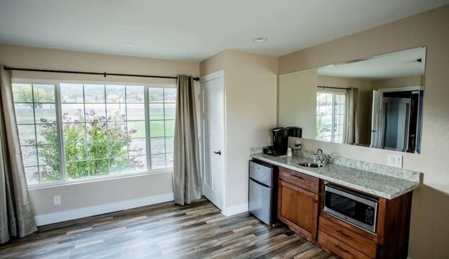 1 bedroom with a king-size bed, one bathroom, and kitchenette.