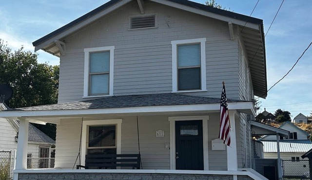 Cheerful home with front porch swing.