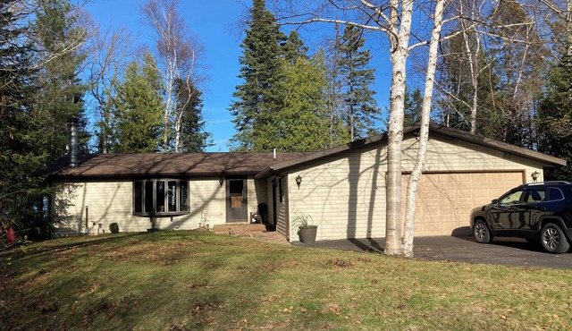 Home on Lake Huron with sandy beach and beautiful yards in Cheboygan, Michigan