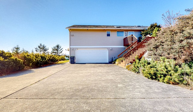 Peek-a-boo ocean view home with outdoor living space, W/D, and balcony