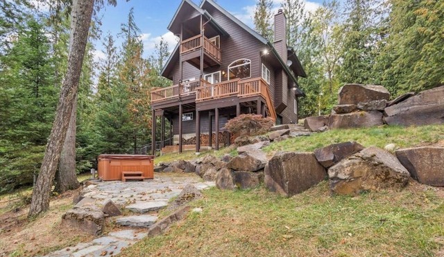 Riverfront home with mountain view, hot tub, deck, WiFi, W/D, & fireplace
