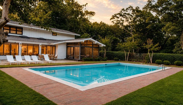 Spacious 7BR home featuring a private pool, separate pool house, game room, Peloton-equipped workout sunroom, dedicated office, multiple living areas, and a fully equipped kitchen—perfect for families, groups, and extended stays.