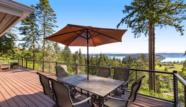 Stunningly situated home with expansive deck & mountain/water views